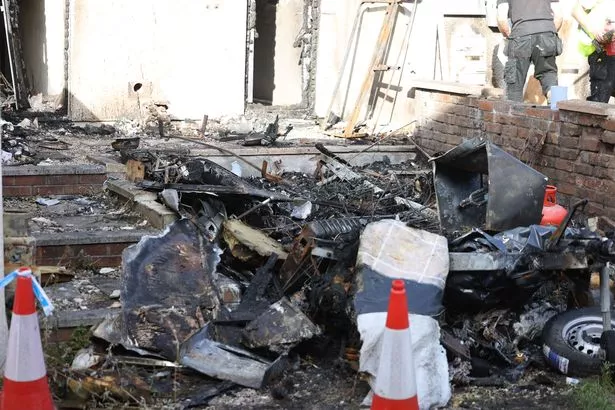 Police and fire forensic investigators at the scene of a caravan fire, Wednesday 1 October 2025 on Marling Road St George Bristol.