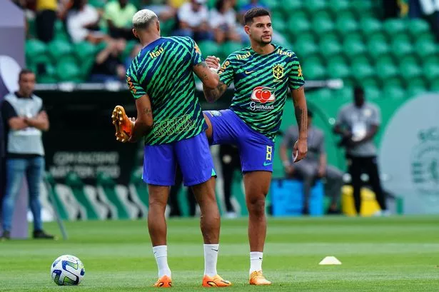 LISBON, PORTUGAL - JUNE 20: Bruno Guimaraes of Brazil with Joelinton of Brazil in action during the warm up before the start of the International Friendly match between Brazil and Senegal at Estadio Jose Alvalade on June 20, 2023 in Lisbon, Portugal.  (Photo by Gualter Fatia/Getty Images)