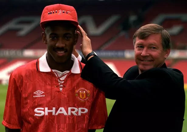 Dion posing with Alex Ferguson in 1992 after signing to Manchester United