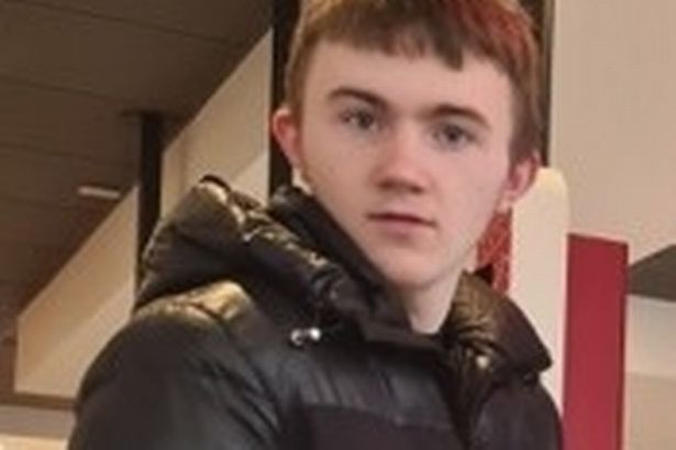 Teenage boy with brown hair wearing puffer coat