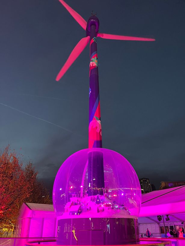 The Christmas tree has been replaced with a wind turbine with a snow globe attached to the bottom of it