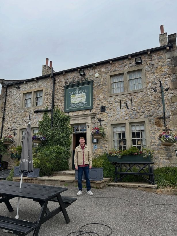 Macaulay standing outside the Woolpack