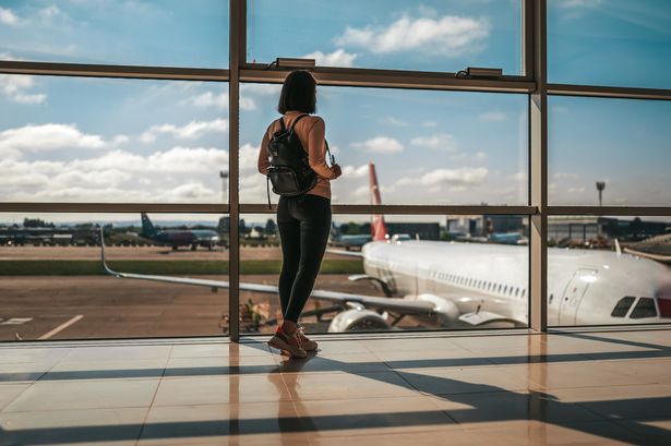 Photo of happy traveler waiting for the flight in airport