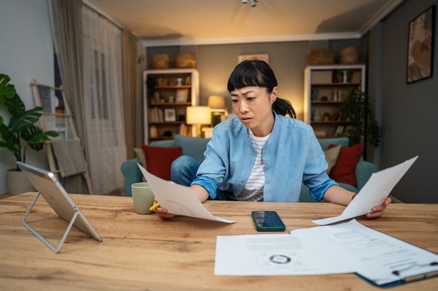 Asian woman feel distressed managing finances, paying bills and taxes at home