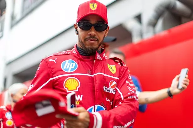 Lewis Hamilton of Great Britain and Ferrari walks in the paddock during qualifying ahead of the F1 Grand Prix of Singapore at Marina Bay Street Circuit on October 4, 2025 in Singapore, Singapore.