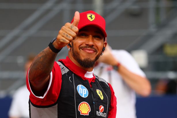 Lewis Hamilton of Great Britain and Scuderia Ferrari gives a thumbs up on the drivers parade prior to the F1 Grand Prix of Singapore at Marina Bay Street Circuit on October 05, 2025 in Singapore, Singapore.