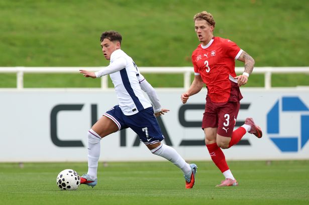 Shea Lacey of England and Loris Giandomenico of Switzerland battle for possession during the international friendly match at St Georges Park 