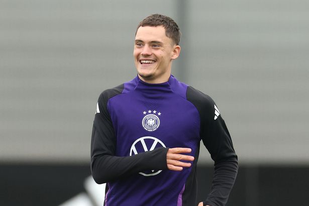 HERZOGENAURACH, GERMANY - OCTOBER 12: Florian Wirtz of Germany smiles during a training session at adidas Homeground on October 12, 2025 in Herzogenaurach, Germany.  (Photo by Alexander Hassenstein/Getty Images)