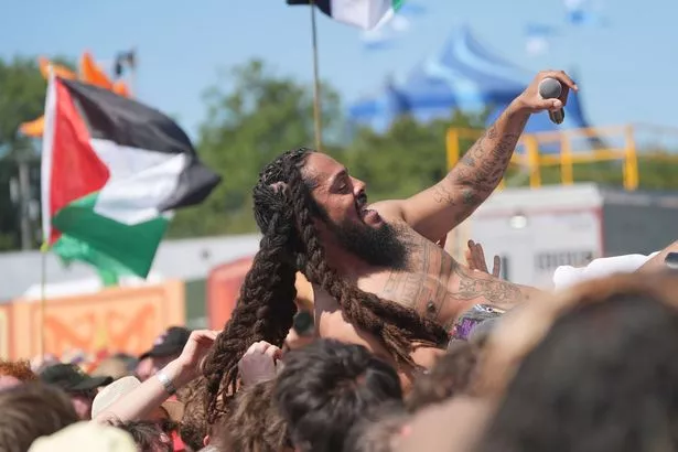 Bob Vylan's frontman crowd surfs during their Glastonbury set