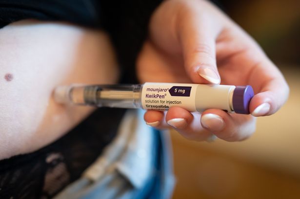 A woman injecting herself with Mounjaro