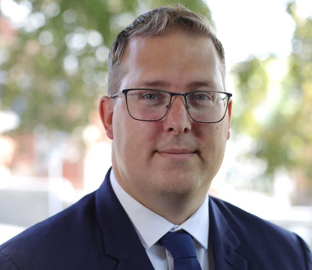 Man wearing glasses in a suit