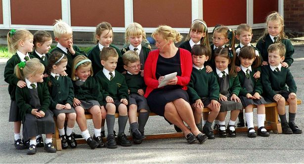 Administration officer Alison Harley inspects nine sets of twins who join the reception class intake at St PaulÕs and St TimothyÕs Infant School in West Derby, Liverpool, Wednesday 15th September. The school already has five other sets - meaning every one in six pupils is a twin. 1999