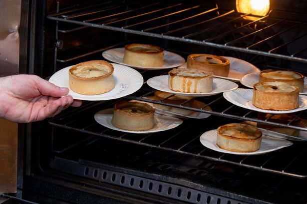 Pies being put into the oven