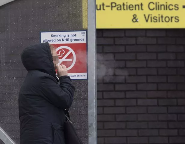 A person smoking outside a hospital