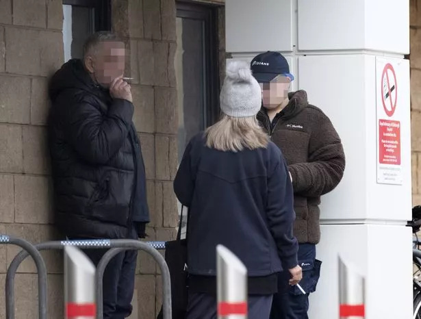 People smoking outside hospital