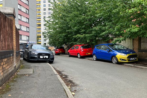 Cars parked on Change Way in Salford.