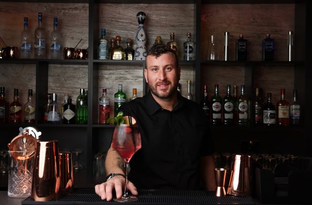 Terry Foster with one of the bar's signature cocktails