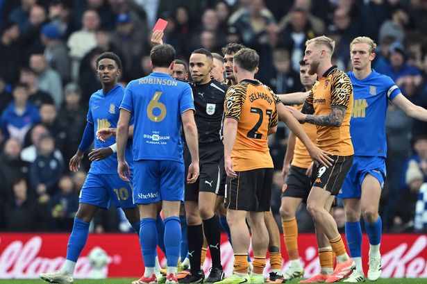 Referee Ruebyn Ricardo shows Jack Robinson a red card during Birmingham City's defeat to Hull City