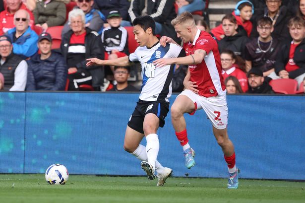 Birmingham City midfielder Paik Seung-ho holds off his marker against Bristol City