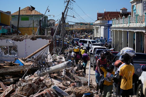 Residents jam a street in Black River, Jamaica, Thursday, Oct. 30, 2025, in the aftermath of Hurricane Melissa