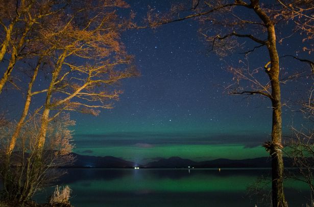 A picture of northern lights over Loch Lomond and The Trossachs national park
