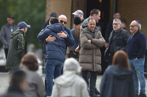 Mourners attend the funeral of Adrian Daulby 