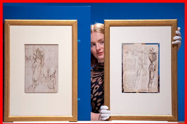 A picture of Exhibition project manager Lara Drew with artworks by Michelangelo Buonarroti and Leonardo da Vinci 
