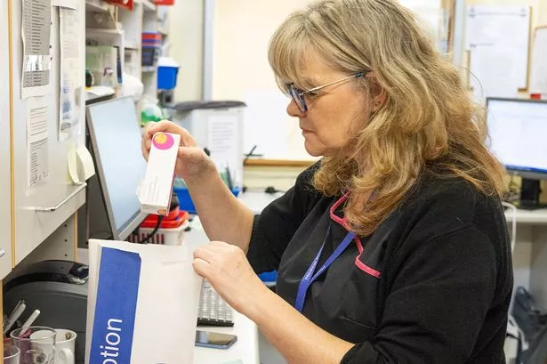 A person making up a prescription