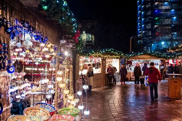 People at the Christmas Market set up in St Enoch Square, a public square of Glasgow.