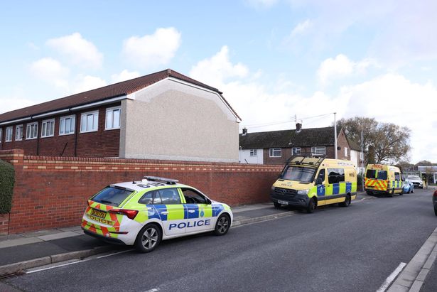 A police car and three vans were parked up