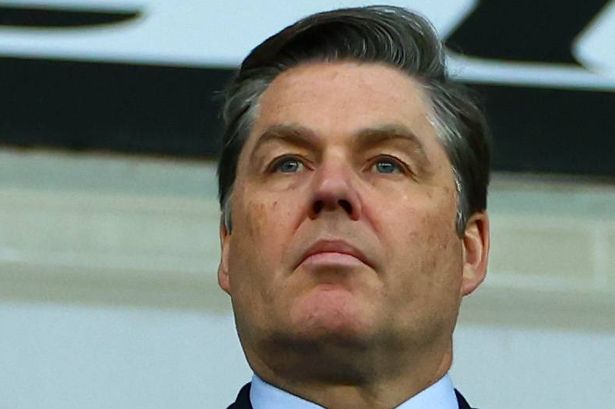 Richard Masters watches a football match from the stands