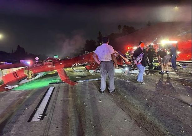 People stand at the scene of the crash