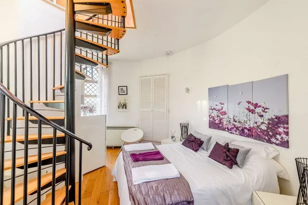 Interior of the folly, spiral staircase and double bed