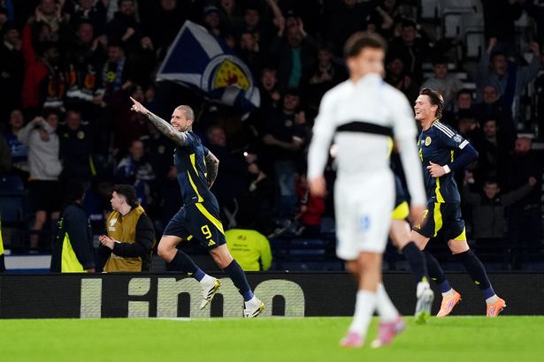 Lyndon Dykes celebrates scoring Scotland's third goal
