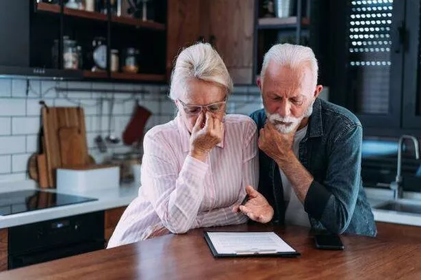 Senior couple discussing financial documents home