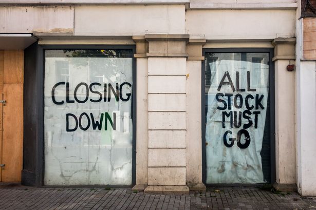 A Closed Down Empty Shop On A Town High Street