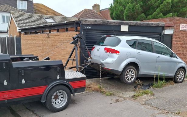 A car being lifted as part of the seizure 