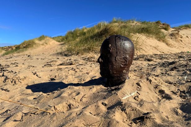 Iron Man a Crosby Beach up to his shoulders on Crosby Beach