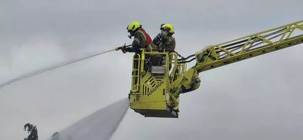 Crews used an extended ladder to help dampen the flames