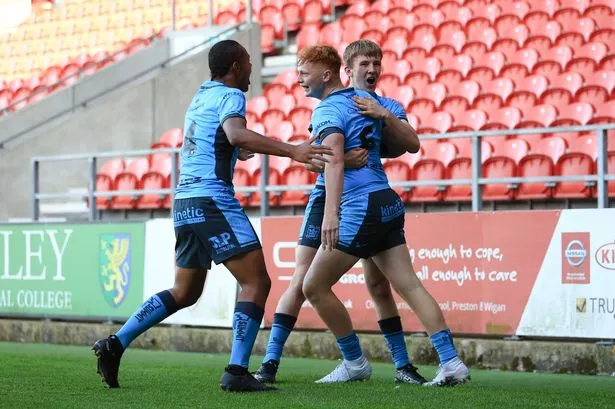 Hull FC scholarship celebrate Kingsley Sharpe's try at St Helens. 
