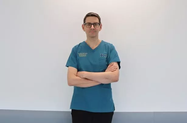 A male doctor with arms folded