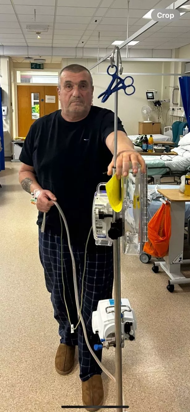 A man in hospital with a drip
