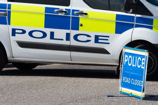 Police Car and Road Closed Sign (file image)