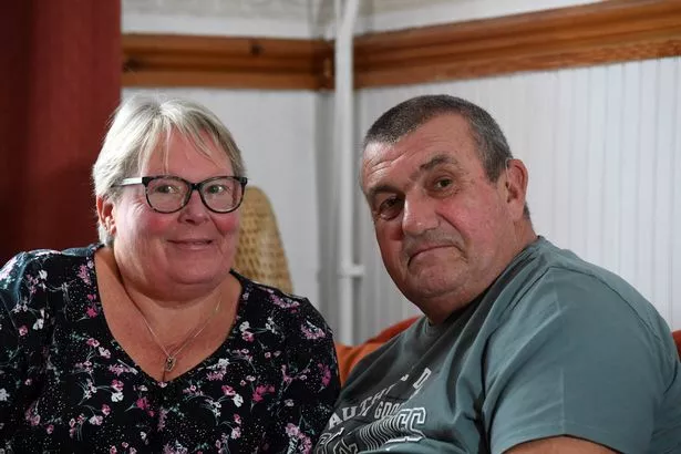 A man and a woman sitting on a sofa