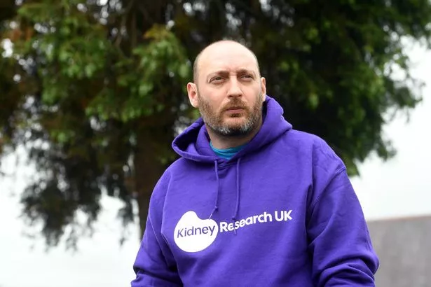 A man in purple hoodie