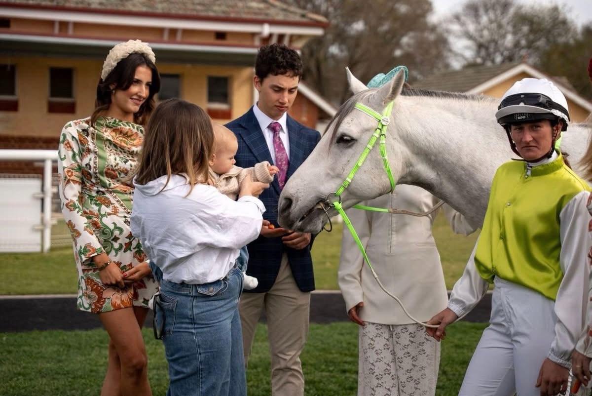 A jockey showing people her horse
