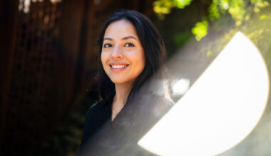 Ana Solorzano, a computer science student, smiles against a leafy backdrop.