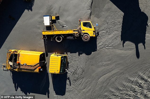 An aerial image shows trucks swamped by mud after a barrier lake burst at Guangfu township in Hualien on September 25, 2025