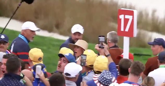 In the video, Rory McIlroy's wife looked around shocked to see where the drink had come from after it struck her hat