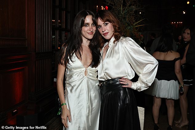 Molly, 57, looked stylish in a white long-sleeved satin blouse and black leather midi skirt